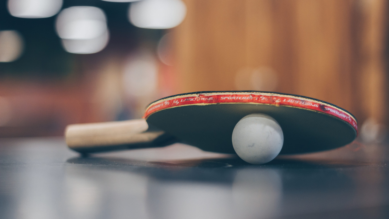 Selective focus photo of table tennis ball and ping pong racket