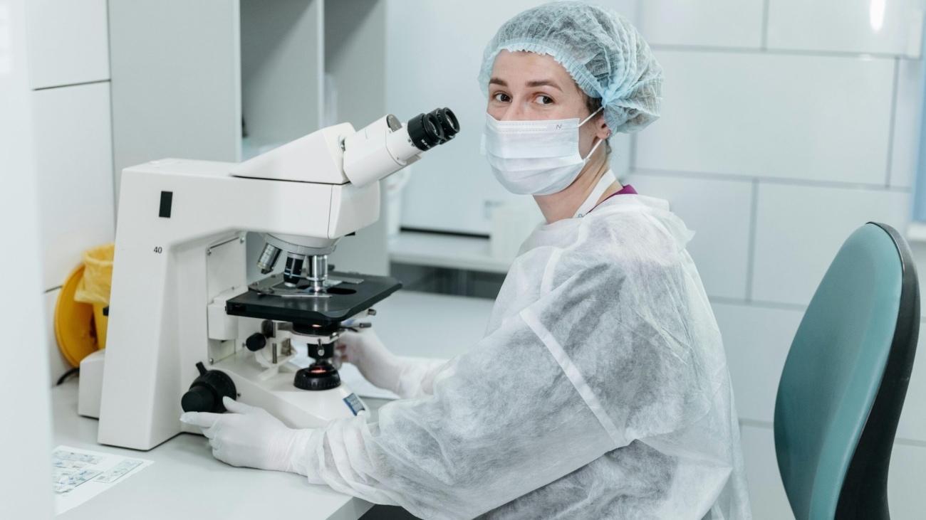 Scientist using a microscope in a laboratory